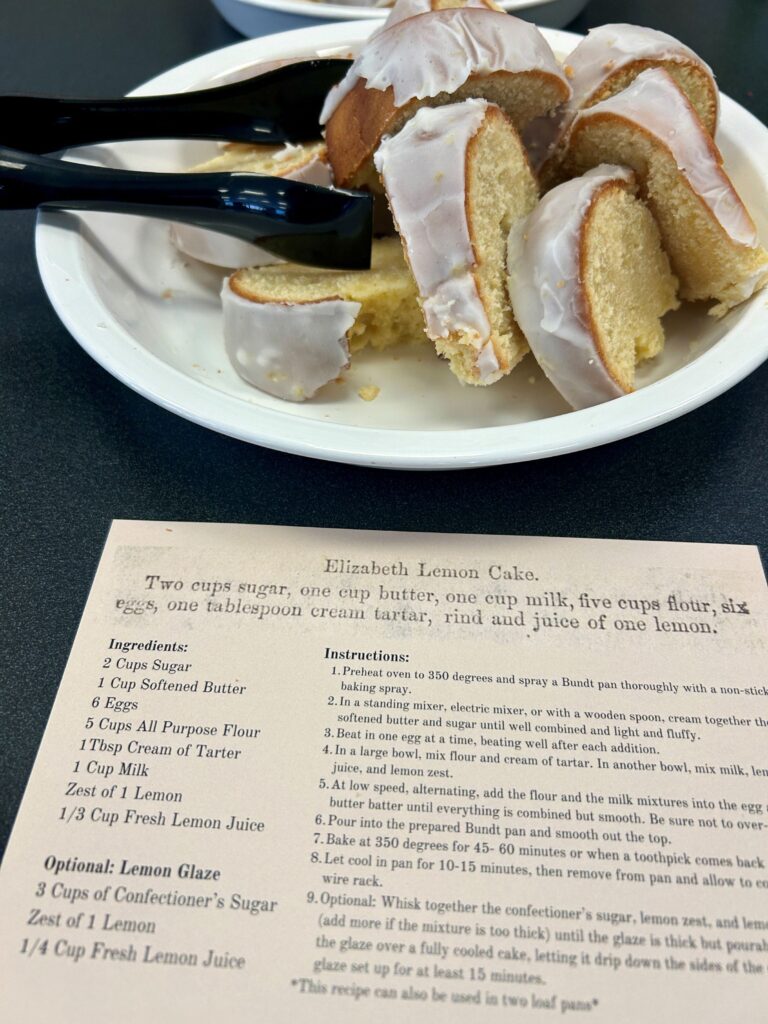 slices of frosted bunt cake arranged on a plate above a recipe card for Elizabeth Lemon Cake